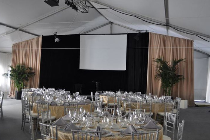 event tables and chairs inside white tent